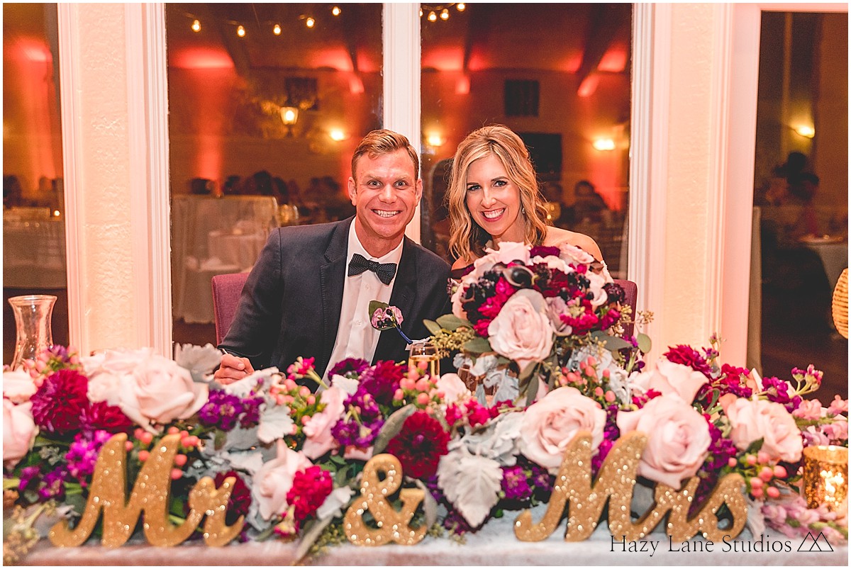 large floral decor on sweetheart table at wedding reception